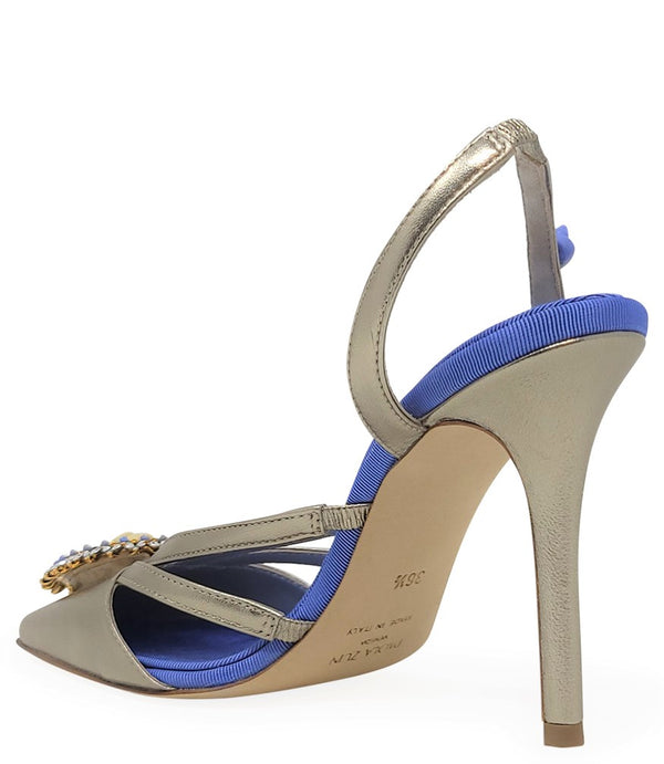 Handcrafted high-heel slingback sandal made in Italy, featuring a strappy upper, sculpted cameo embellishment with crystal detailing on the toe, and a smooth stiletto heel. Padded insole with contrast texture, shown from multiple angles against a clean ba