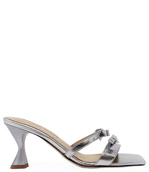 Women's open-toe sandal with a molded footbed, slip-on design, and decorative front strap featuring an embellished gemstone medallion. Crafted from smooth leather with a flat rubber sole. Designed in Italy by Madison Maison