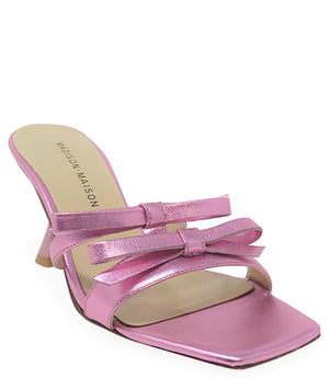 Women's open-toe sandal with a molded footbed, slip-on design, and decorative front strap featuring an embellished gemstone medallion. Crafted from smooth leather with a flat rubber sole. Designed in Italy by Madison Maison