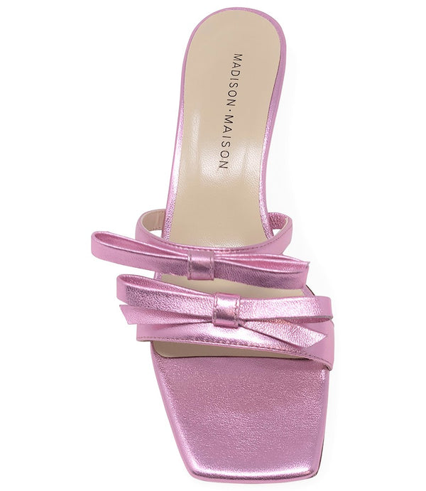 Women's open-toe sandal with a molded footbed, slip-on design, and decorative front strap featuring an embellished gemstone medallion. Crafted from smooth leather with a flat rubber sole. Designed in Italy by Madison Maison