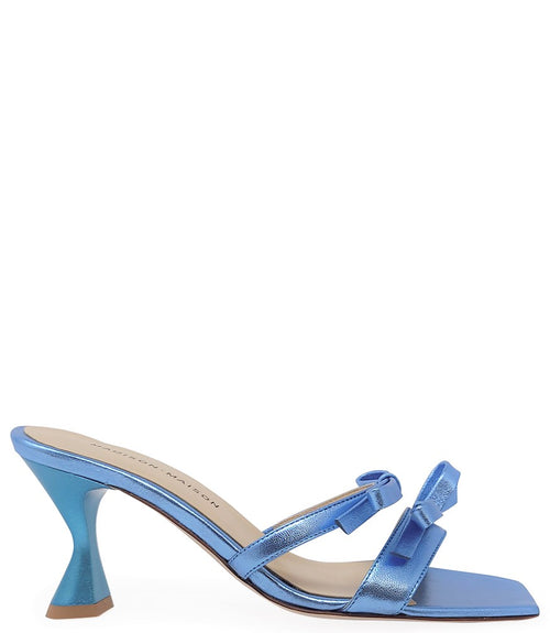 Women's open-toe sandal with a molded footbed, slip-on design, and decorative front strap featuring an embellished gemstone medallion. Crafted from smooth leather with a flat rubber sole. Designed in Italy by Madison Maison