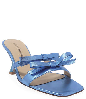 Women's open-toe sandal with a molded footbed, slip-on design, and decorative front strap featuring an embellished gemstone medallion. Crafted from smooth leather with a flat rubber sole. Designed in Italy by Madison Maison