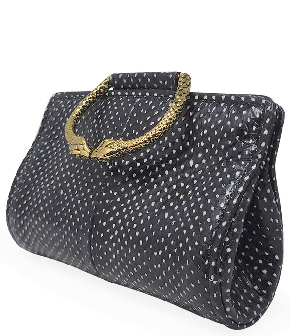 Structured mini handbag crafted from textured leather with a dotted pattern, featuring a sculptural metal snake-shaped top handle with dual serpent heads. Includes a detachable adjustable leather strap with metal clasps for versatile wear as a crossbody o