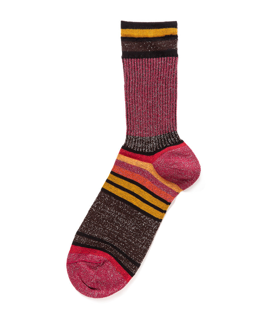 A mid-calf knit sock featuring a mix of textured panels, ribbed leg section, and bold horizontal stripes around the arch and cuff.