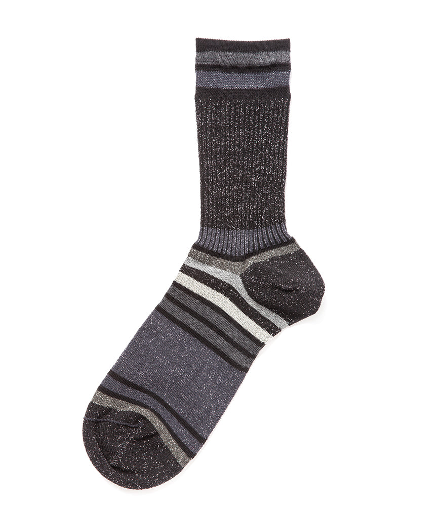 A mid-calf knit sock featuring a mix of textured panels, ribbed leg section, and bold horizontal stripes around the arch and cuff.