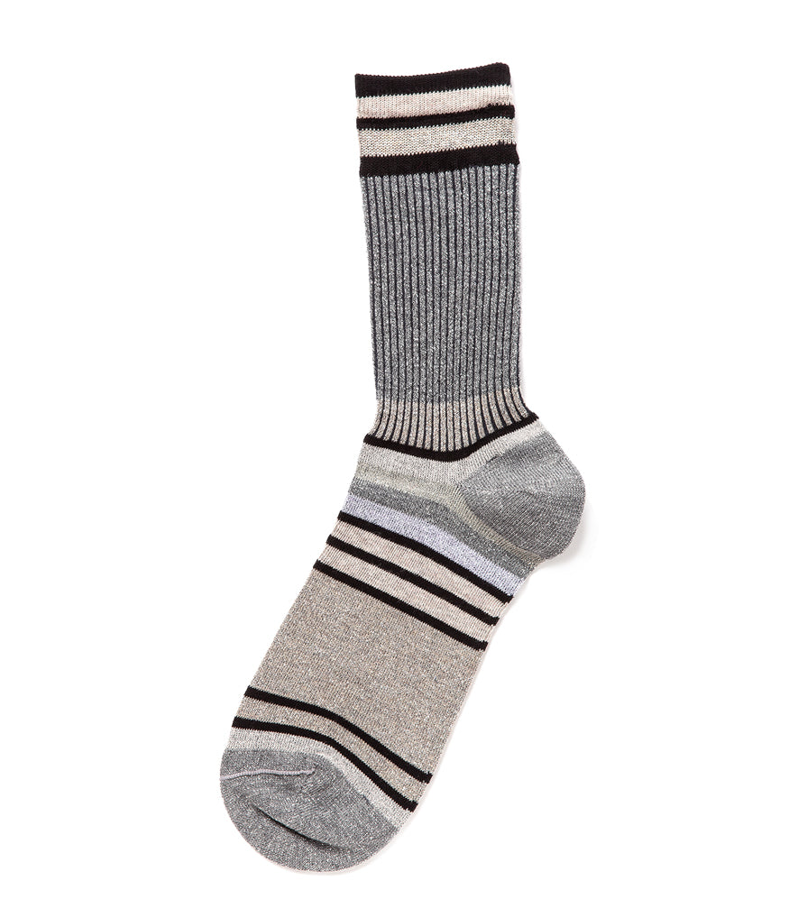 A mid-calf knit sock featuring a mix of textured panels, ribbed leg section, and bold horizontal stripes around the arch and cuff.