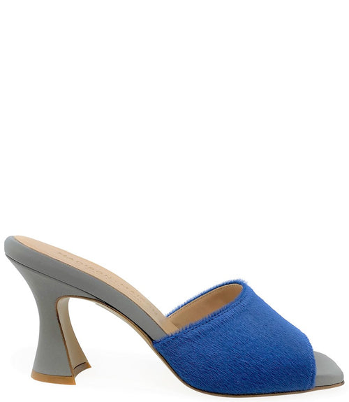 Handcrafted Italian mule with an open toe, flared heel, and a two-tone design. Features a wide vamp strap and cushioned insole for added comfort. Shown from multiple angles against a clean background