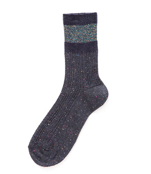 A mid-calf knit sock featuring a mix of textured panels, ribbed leg section, and bold horizontal stripes around the arch and cuff.