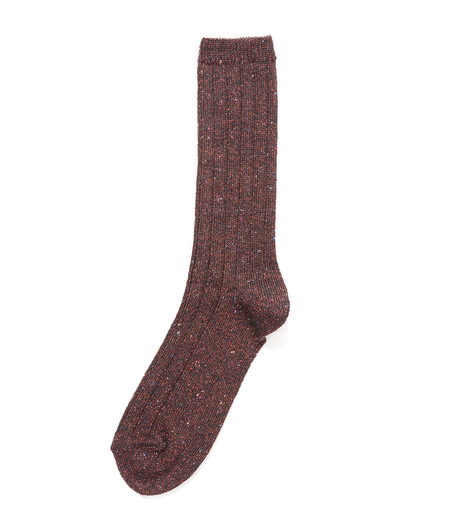 A mid-calf knit sock featuring a mix of textured panels, ribbed leg section, and bold horizontal stripes around the arch and cuff.
