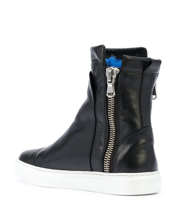 Ankle-high leather sneaker with side zipper closure, cushioned sole, and smooth panel construction. Features a rounded toe, pull tab at the heel, and soft interior lining.