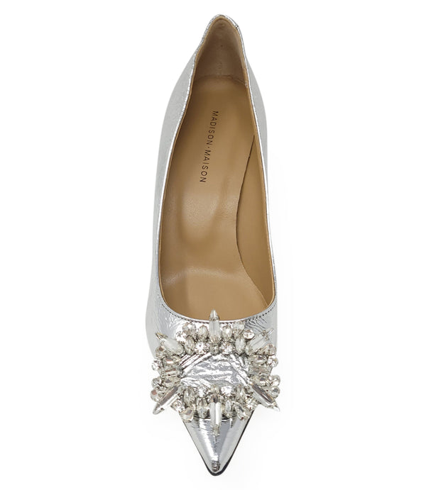 Pointed-toe pump crafted from premium leather with a softly crinkled finish, featuring an embellished jeweled buckle at the toe and a sculpted flared kitten heel. Designed with a leather-lined interior and a leather outsole for comfort and durability. Ele