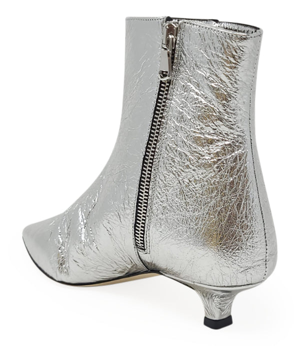 Pointed-toe ankle boot crafted from crinkled metallic leather, featuring a sleek side profile and a low kitten heel. Designed with a side zip closure for easy wear, a leather-lined interior for comfort, and a durable leather outsole. Contemporary and stre