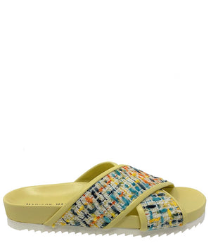 A handcrafted Italian open-toe flat sandal featuring a wide strap with a centered oval gemstone surrounded by circular studs, set on a molded footbed with a low platform sole."