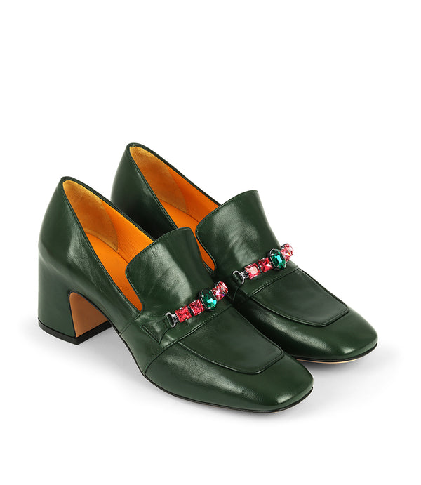 A leather heeled loafer with a block heel and square toe, featuring a decorative band with faceted gemstone-style embellishments across the upper. Designed by Madison in Beverly Hills and handcrafted in Italy.