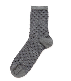 A mid-calf knit sock featuring a mix of textured panels, ribbed leg section, and bold horizontal stripes around the arch and cuff.