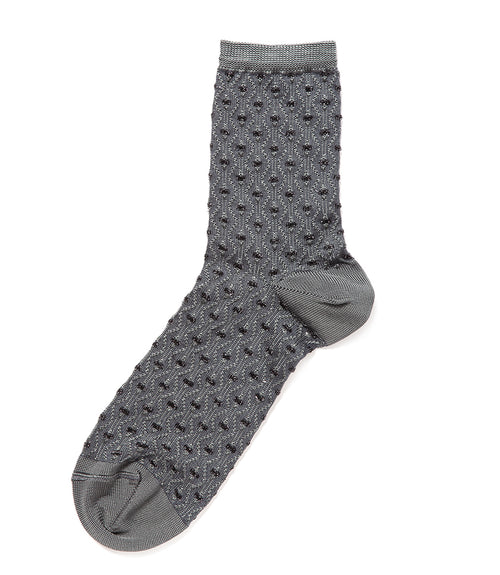 A mid-calf knit sock featuring a mix of textured panels, ribbed leg section, and bold horizontal stripes around the arch and cuff.